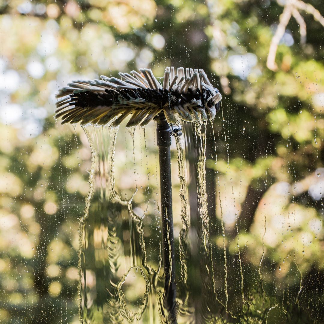 window brush with water on a window